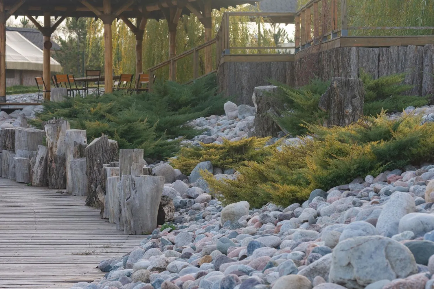 A wooden walkway surrounded by rocks and trees